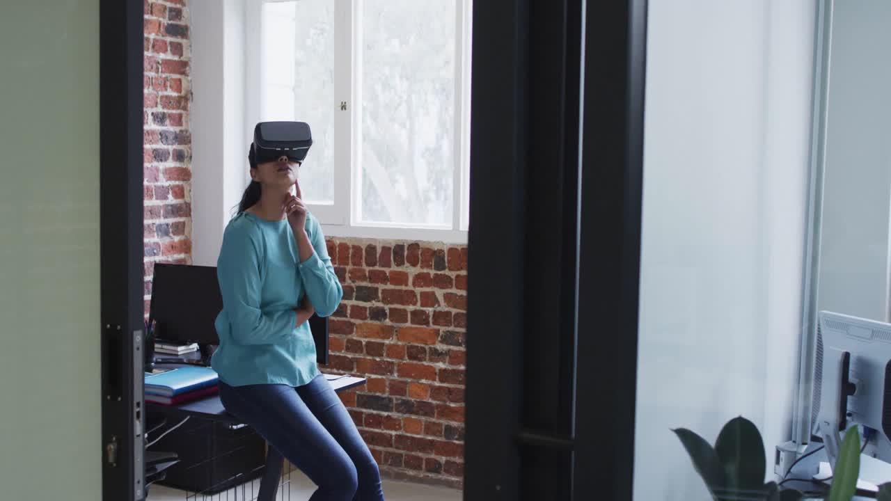Woman using VR headset at office
