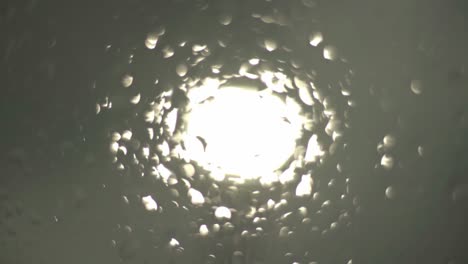 light seen through glass with water droplets