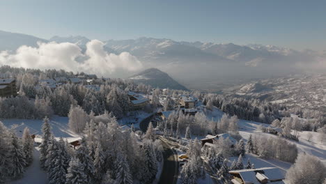 Aerial-shot-in-Switzerland-over-the-town-of-Crans-Montana,-Valais