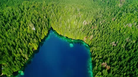 tranquil mountain lake in italian alps, towering peaks, laghi di fusine, drone
