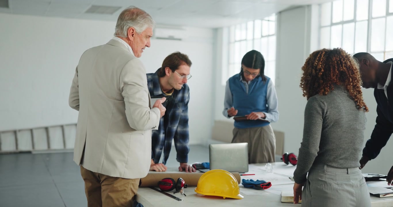 Diverse Team of Architects Collaborating on Construction Project in Office