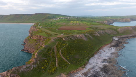 coastal cliff landscape with village and farmland