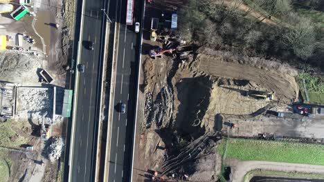 Static-drone-shot-of-a-highway-with-a-construction-site-at-either-side-of-the-highway