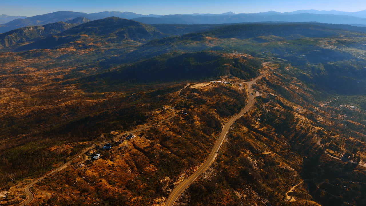 Rare houses in the bare rocks of Sierra National Forest, California, USA. Highways crossing the mountains. Top view.