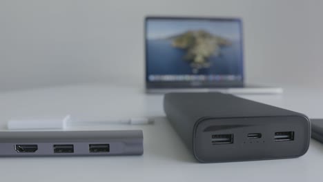 laptop, power bank, and hub on a table