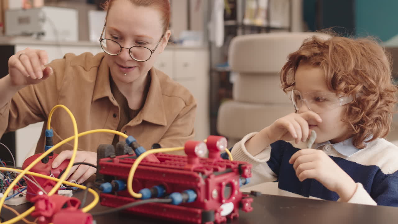 Adult and child collaborate on a robotics project