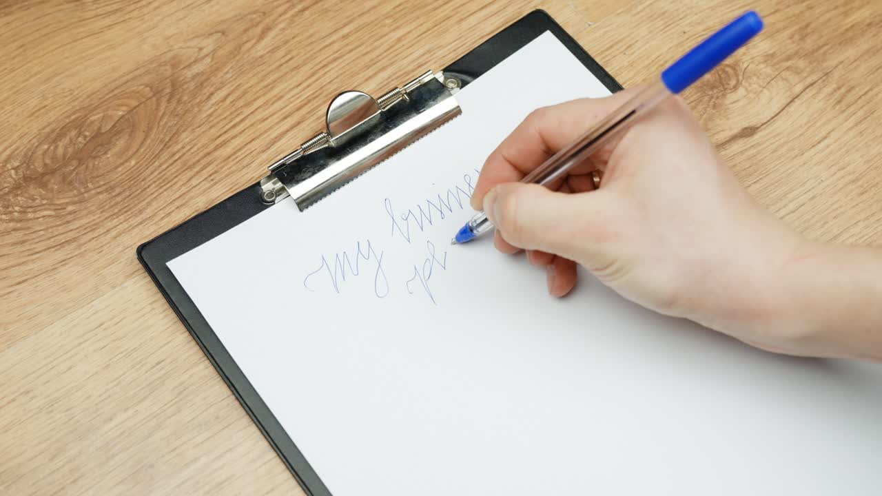 Handwriting on clipboard, creative planning start up with blue pen on wooden desk