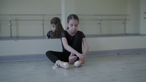 young ballerina practicing dance moves in studio