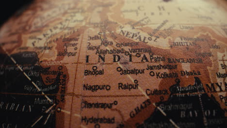 close-up of an old vintage world globe, focused on india