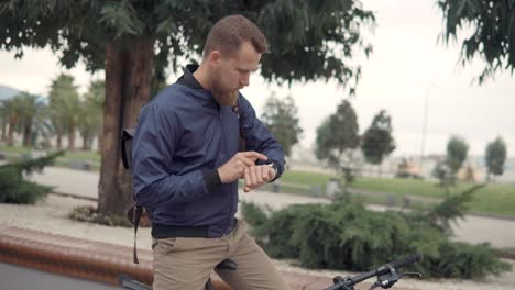 man checking smartwatch outdoors