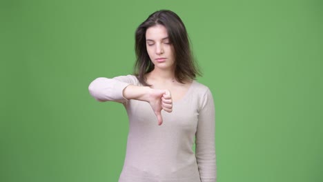 young beautiful woman looking upset and giving thumbs down