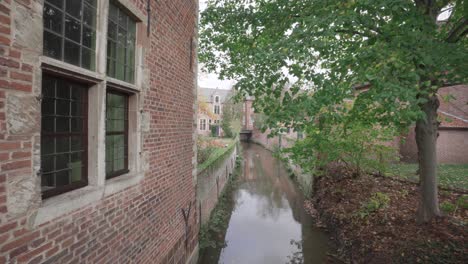 dijle river runs through the great beguinage in leuven, belgium