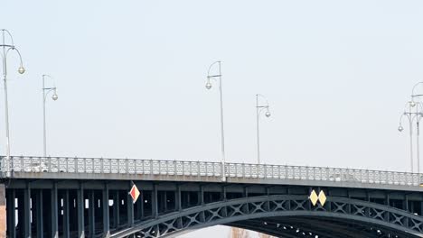 several vehicles driving over the theodor-heuss bridge on a sunny afternoon in mainz