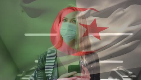 Animation-of-flag-of-algeria-waving-over-woman-wearing-face-mask-during-covid-19-pandemic