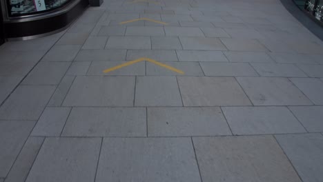 symbols on floor for social distancing during covid19 global pandemic. england