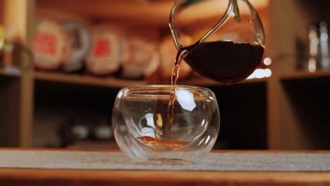 pouring tea or coffee into a double-walled glass cup