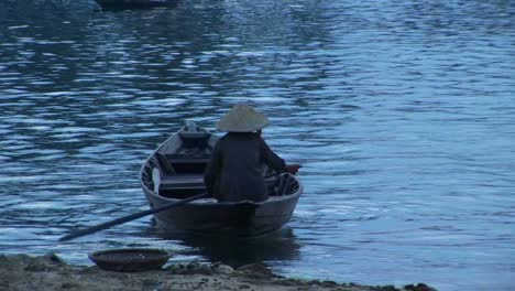 A-boat-is-rowed-across-a-river-in-Vietnam