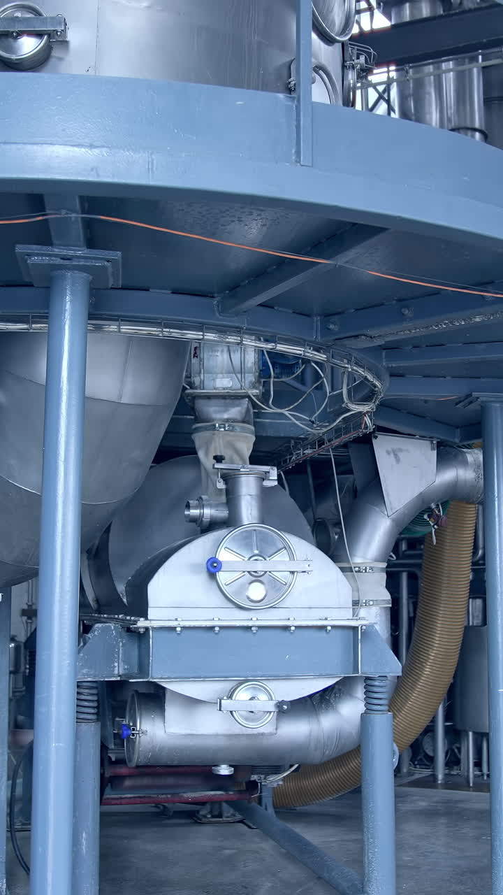Modern food pipelines technology. Big steel construction of milk factory. Vertical video