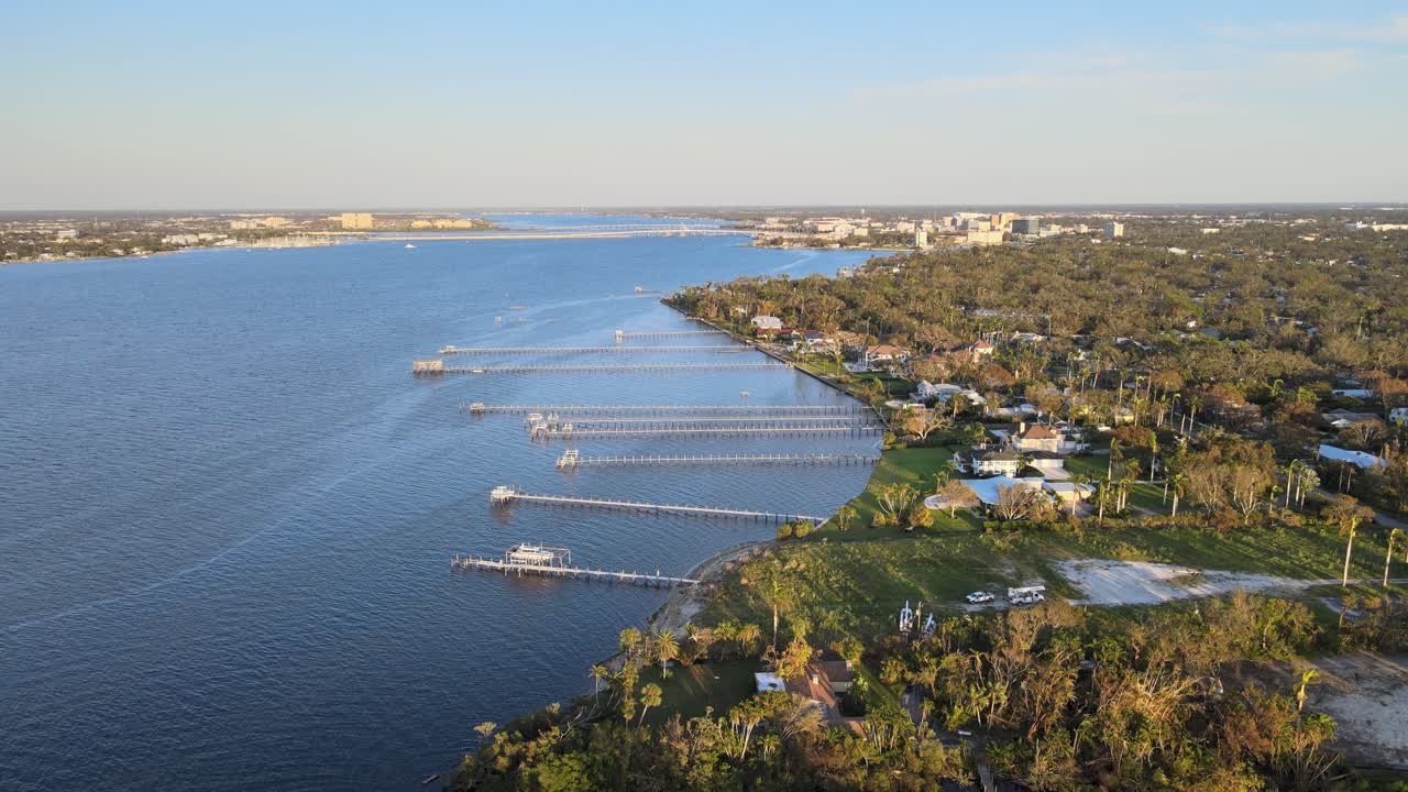 Aerial view of Manatee River with damaged docks, fallen trees, and power restoration efforts. Crane Down