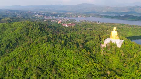 aerial view of a golden buddha statue and temple complex in thailand