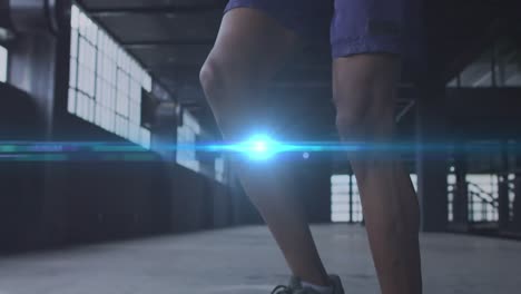 video compuesto digital de un punto azul de luz contra un hombre afroamericano saltando la cuerda