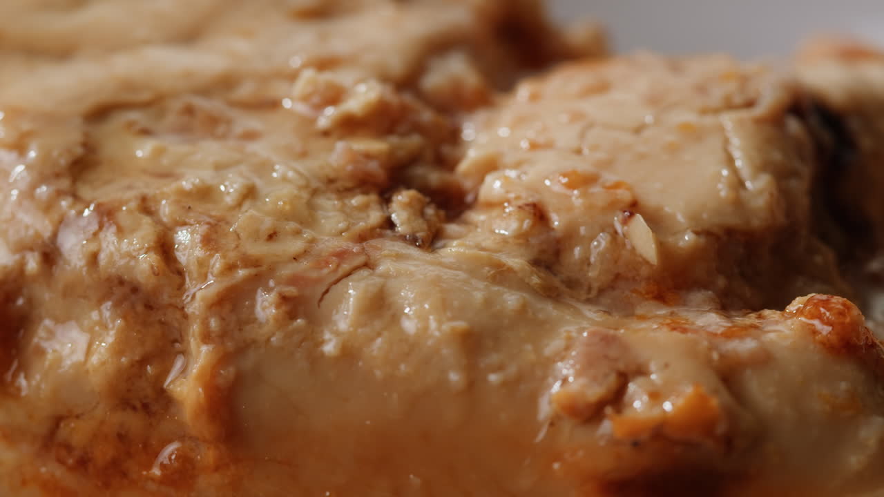 Smoked cod liver in oil in open tin can with fresh greens on wooden table. Seafoods delicacy. High quality 4k footage