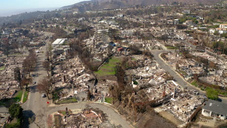 aerial view of a neighborhood devastated by wildfire aftermath