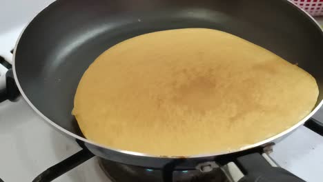 cooking pancakes on a gas stove