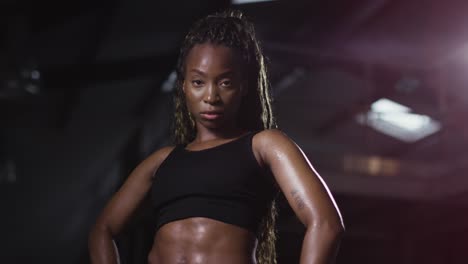 studio portrait of woman wearing fitness clothing standing in gym 4