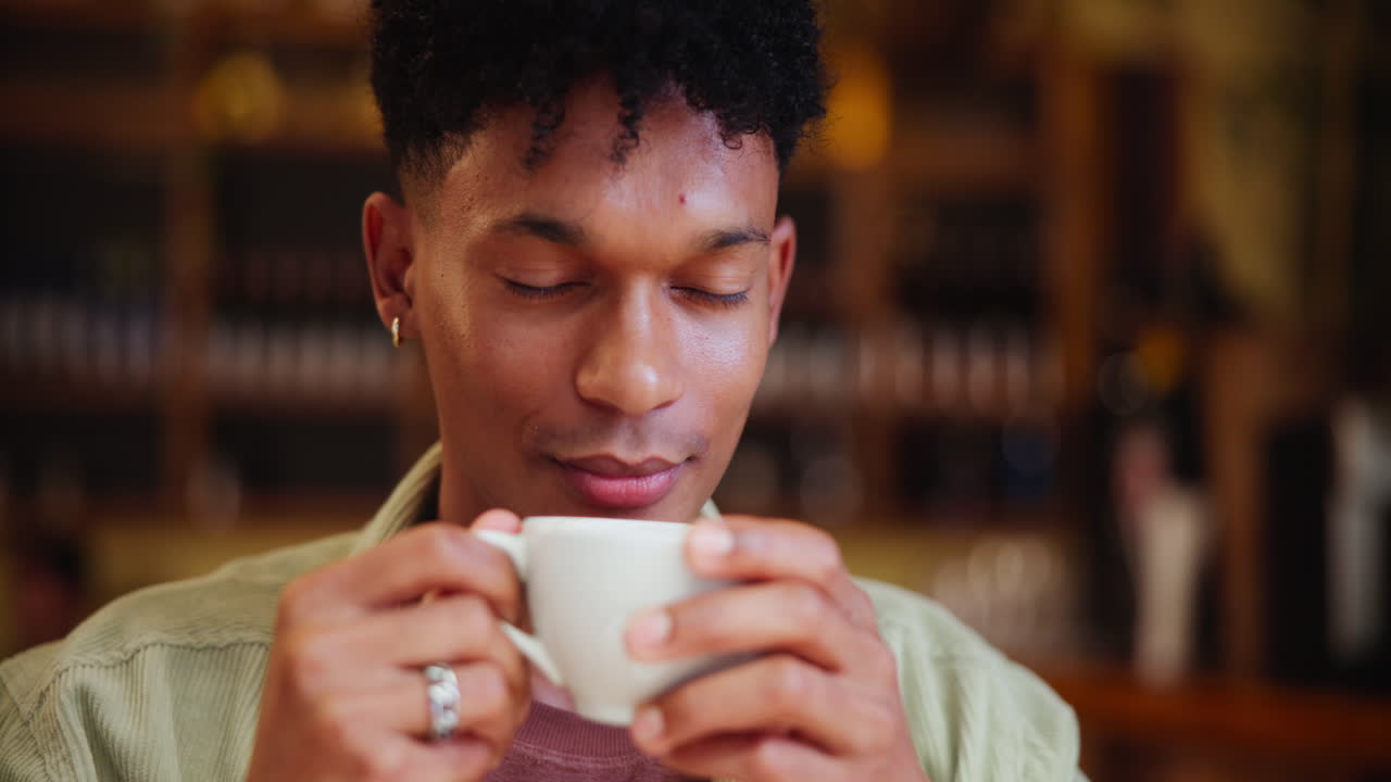Man drinking coffee at cafe