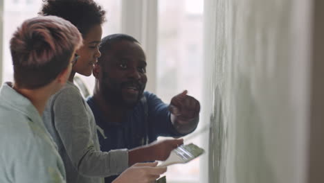 family painting a wall together