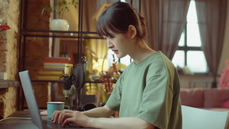 asian woman using laptop at home