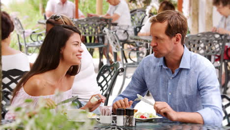 young white adult couple having lunch together outside cafe