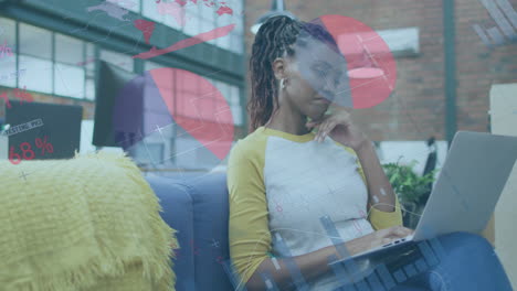 animation of financial data processing over biracial businesswoman using laptop in office
