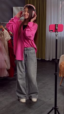 young woman recording fashion content for social media