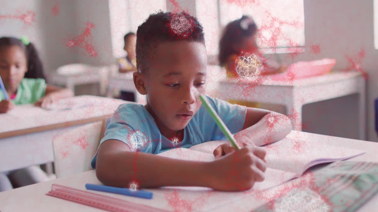 In school, child writing in classroom with red animation overlay patterns