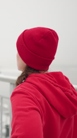 close up of athlete exercising outdoors during winter stretching leg back and forth surrounded by snowy ground foggy atmosphere distant river light poles in background conveying motion focus