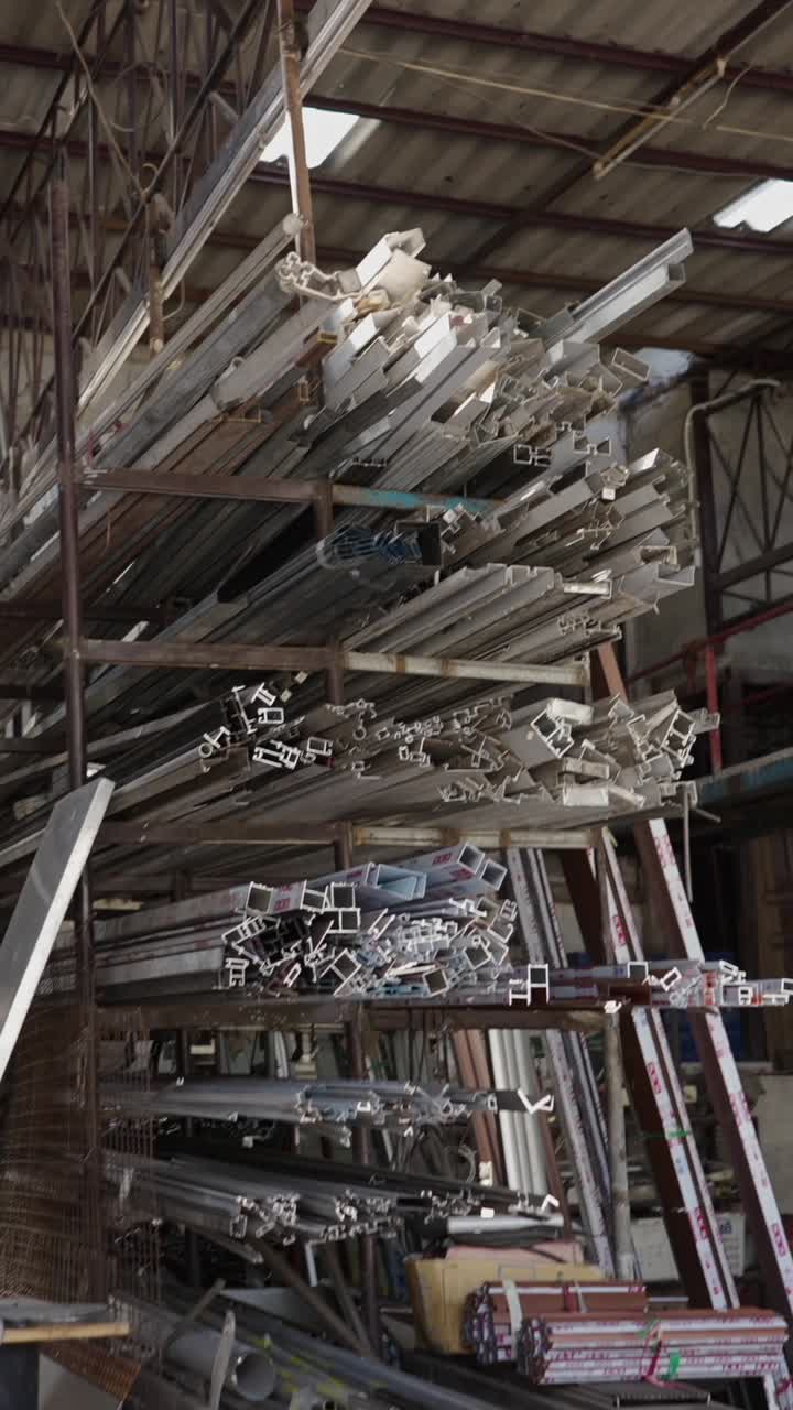 Stacked Aluminum Profiles and Metal Scraps in a Warehouse