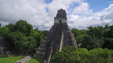 spectacular aerial shot over the tikal pyramids in guatemala