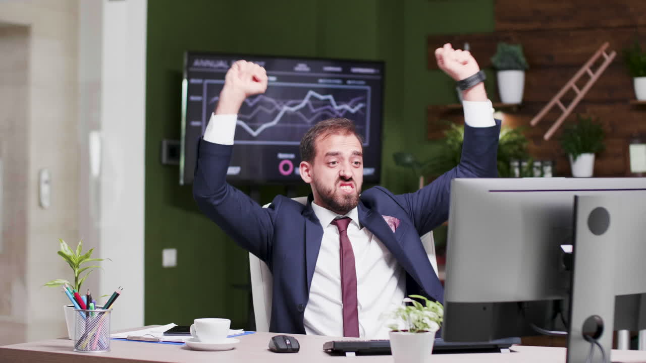 Successful Businessman Celebrating in Office