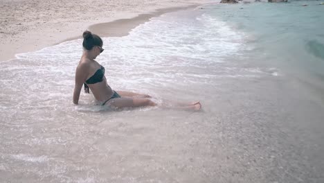 waves wash woman with white thick foam and water splashes