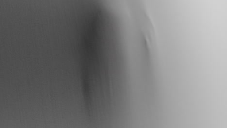 creepy silhouettes of a woman's hands appears from the white surface