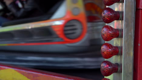 4k-Close-up-of-Blinking-Red-Lights-while-people-are-having-fun-driving-Bumper-Cars-at-the-Fun-Fair