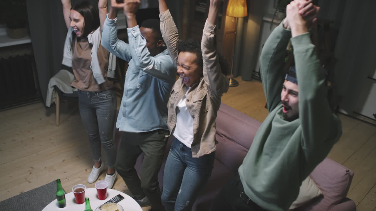 Diverse Friends Cheering While Watching Sports Game