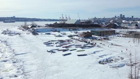 Drone-view-rotate-left,-people-preparing-for-canoe-race