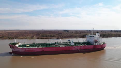 Tanker-ship-on-a-serene-river---aerial-view-fly-over