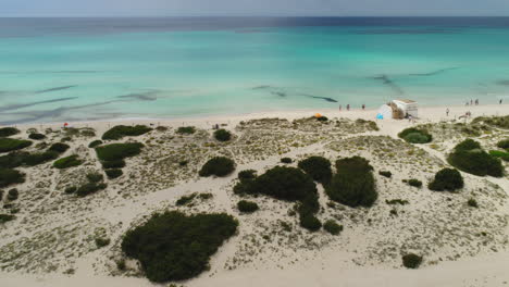 Aerial-Drone-Shot-of-a-beautiful-Beach-in-Spain-with-People-walking-on-it,-4k-UHD