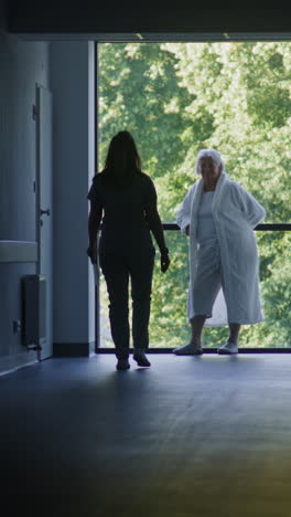 hospital staff caring for elderly patient