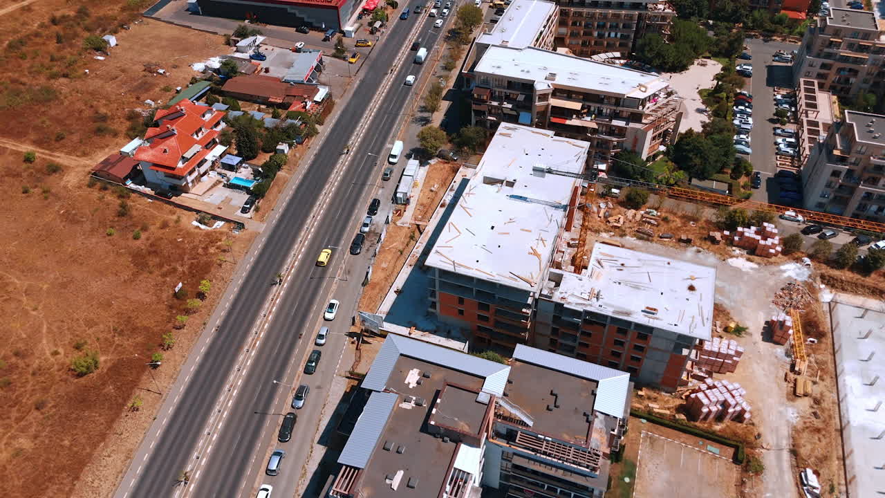 Varna, Bulgaria, 11 July 2025: Sunny highway urban growth. New buildings and ongoing construction are visible along the highway, showcasing urban growth under bright daylight