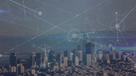 animation of connected dots over aerial view of cityscape with skyscrapers against sea and sky